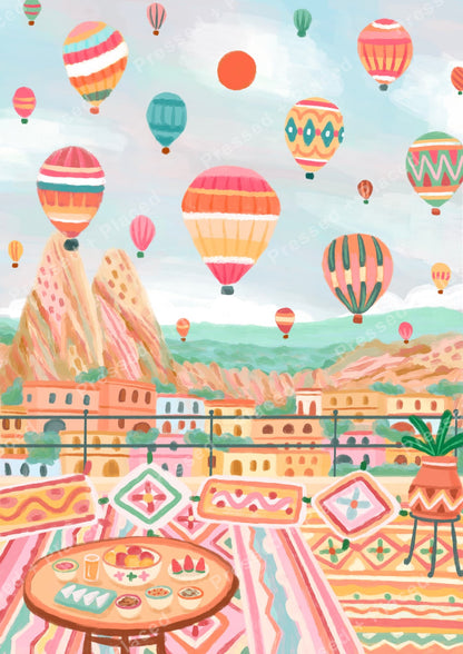 Pastel hot air balloons floating over a colorful hillside cityscape with bohemian patterns