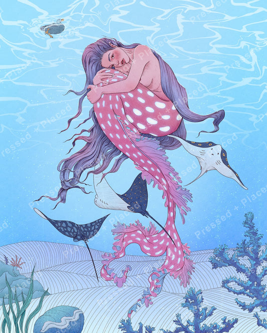 Fantasy mermaid surrounded by ocean rays, coral, and soft blue underwater scenery